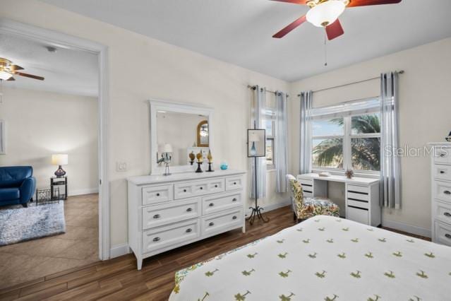 bedroom featuring ceiling fan and dark tile flooring