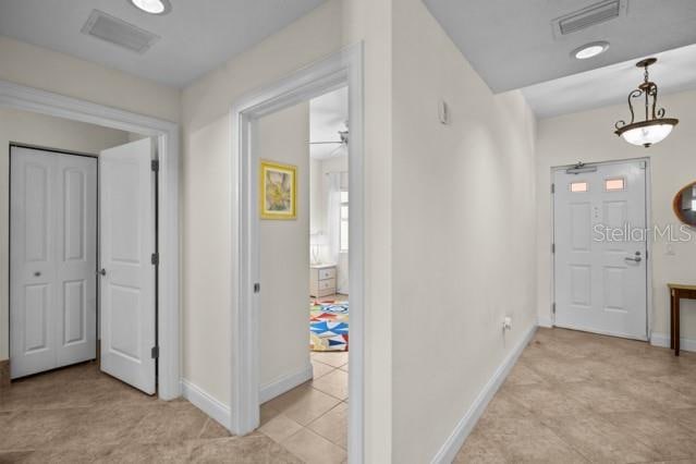 hallway featuring light tile floors