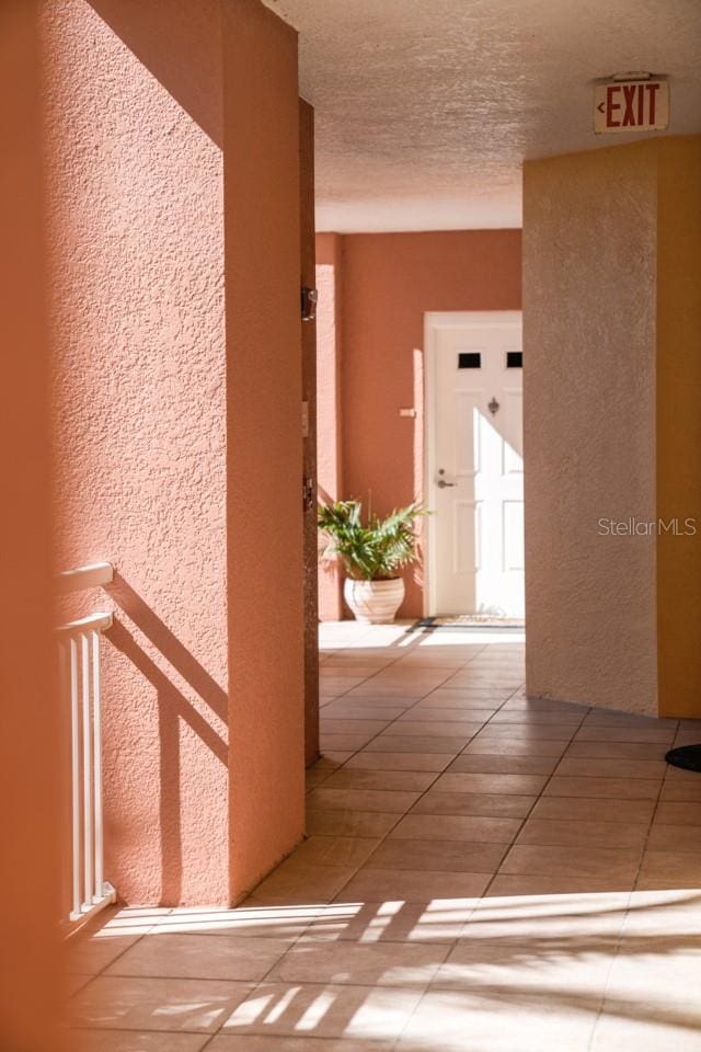 hall featuring light tile floors