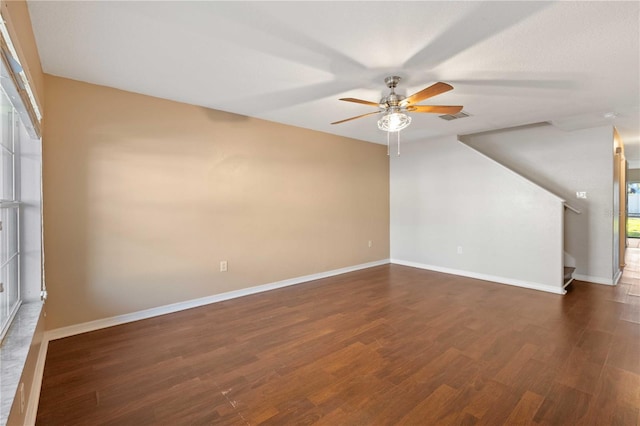 unfurnished room featuring ceiling fan and dark wood-type flooring