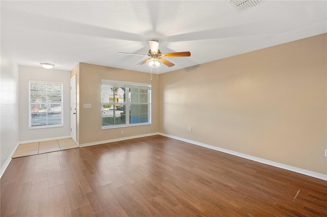 spare room with ceiling fan and hardwood / wood-style flooring