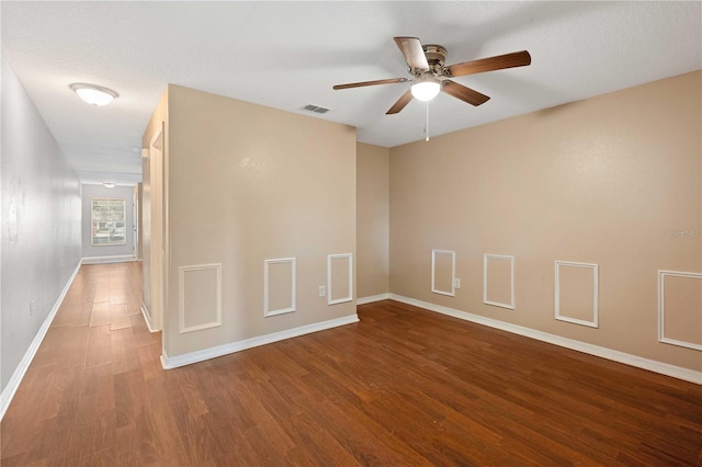 empty room with a textured ceiling, hardwood / wood-style floors, and ceiling fan