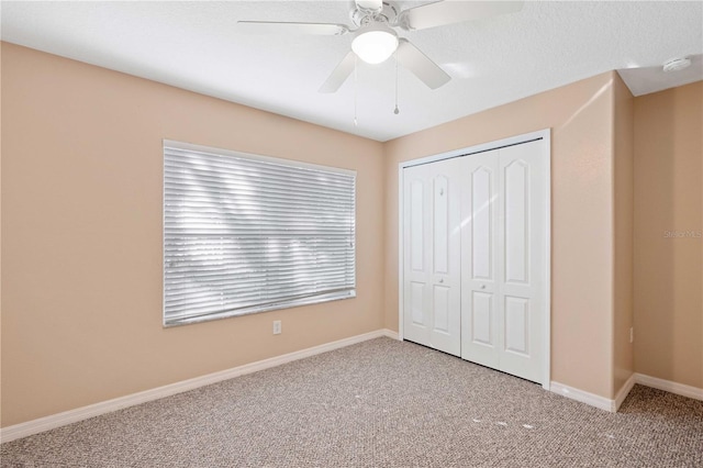 unfurnished bedroom featuring a closet, ceiling fan, and carpet floors