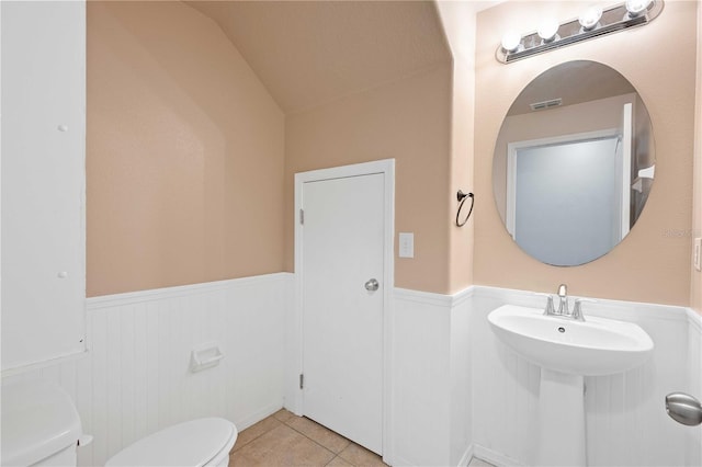 bathroom featuring toilet, tile patterned flooring, and vaulted ceiling