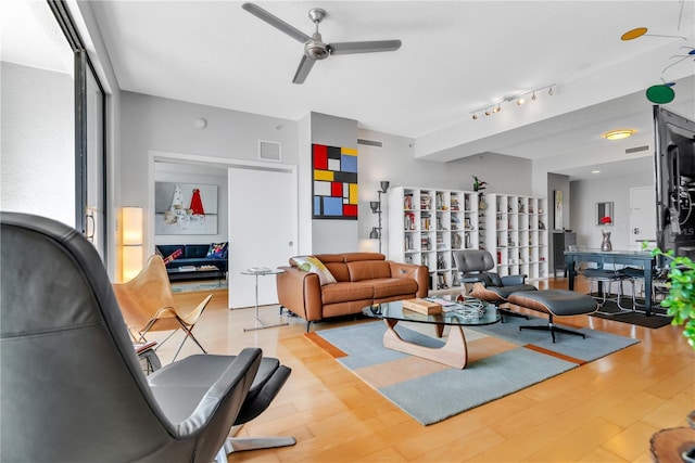 living room with ceiling fan, track lighting, and light wood-type flooring