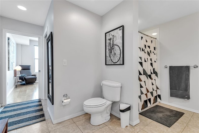 bathroom with tile patterned flooring, a shower with curtain, and toilet