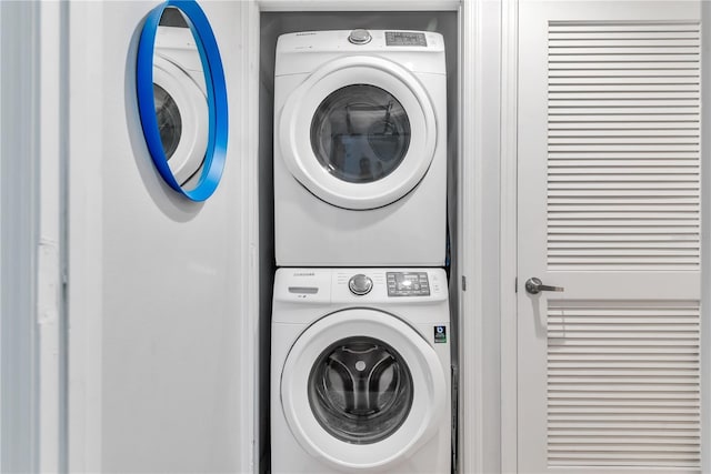 washroom with stacked washing maching and dryer