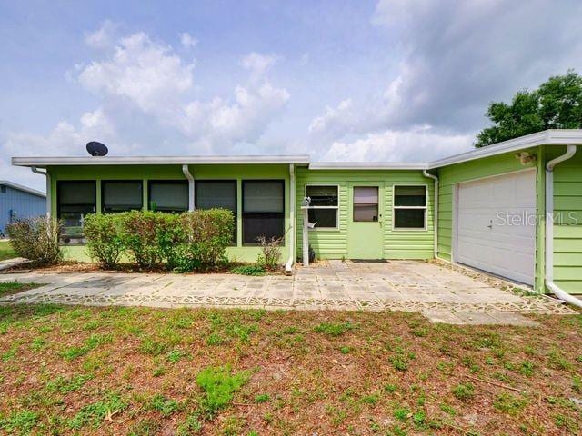 ranch-style home with a front yard and a garage