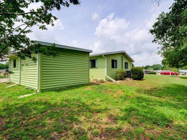 rear view of house featuring a yard