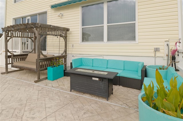 view of patio with a pergola and an outdoor living space with a fire pit