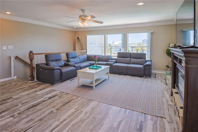 living room with hardwood / wood-style floors, ceiling fan, and crown molding