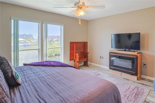 bedroom with light hardwood / wood-style floors and ceiling fan