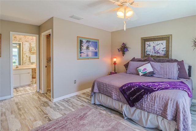 bedroom with connected bathroom, ceiling fan, sink, and light wood-type flooring