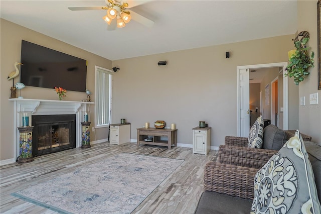 living room featuring wood-type flooring and ceiling fan