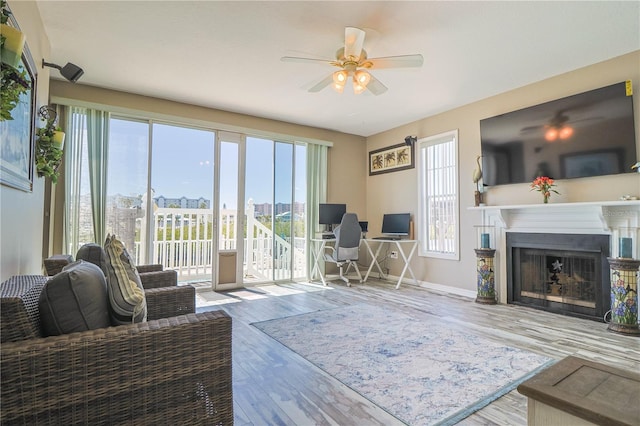 living room featuring plenty of natural light, hardwood / wood-style floors, and ceiling fan