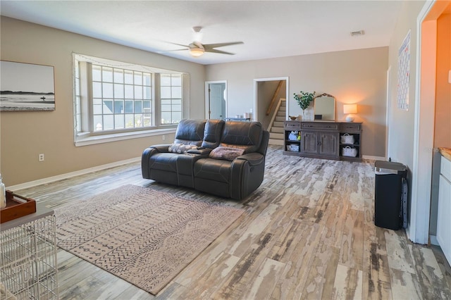 living room featuring wood-type flooring and ceiling fan