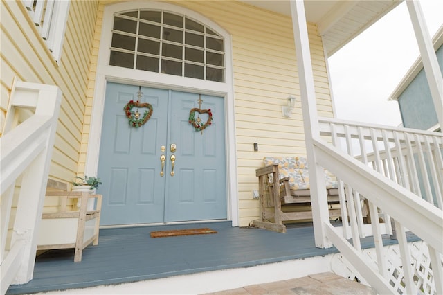 view of exterior entry featuring a porch