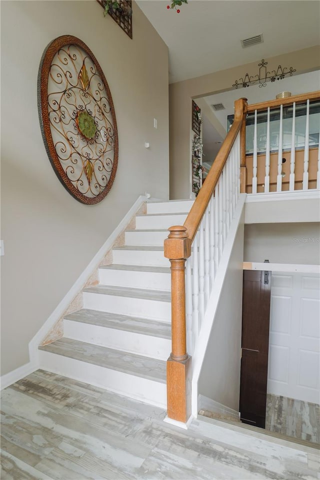 staircase featuring light hardwood / wood-style flooring