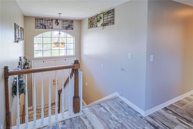 interior space with a notable chandelier and hardwood / wood-style flooring