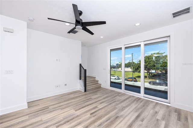 unfurnished living room with ceiling fan, light wood-type flooring, and a textured ceiling