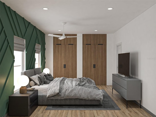 bedroom featuring light hardwood / wood-style flooring and ceiling fan