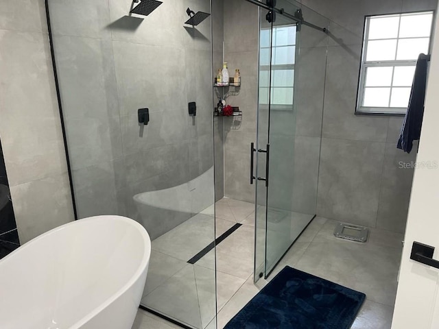 bathroom with tile floors and separate shower and tub