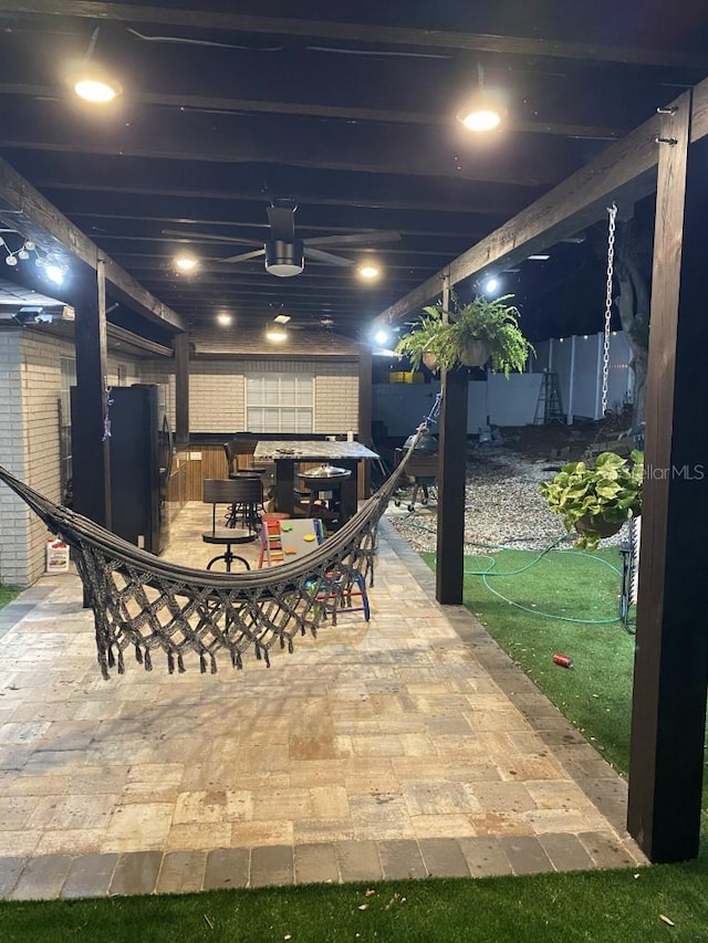 patio terrace at twilight featuring ceiling fan