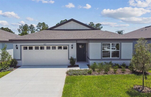 view of front of property with a garage and a front lawn