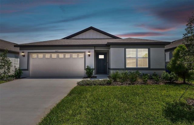 view of front of house with a garage and a yard