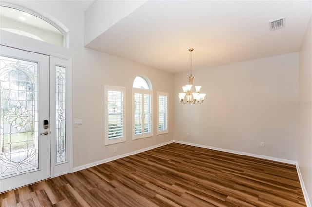 entryway featuring dark hardwood / wood-style flooring and an inviting chandelier