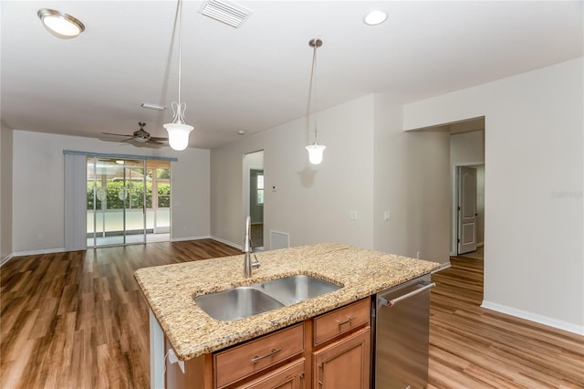 kitchen with hanging light fixtures, ceiling fan, sink, and hardwood / wood-style floors