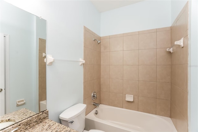 full bathroom featuring tiled shower / bath combo, toilet, and vanity