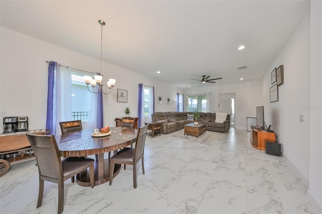 dining room featuring ceiling fan with notable chandelier