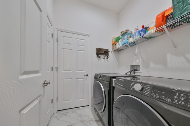 clothes washing area with washing machine and clothes dryer