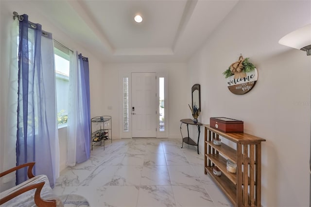 entrance foyer with a raised ceiling