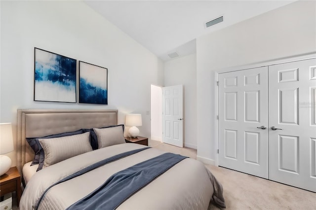 carpeted bedroom featuring a closet and vaulted ceiling