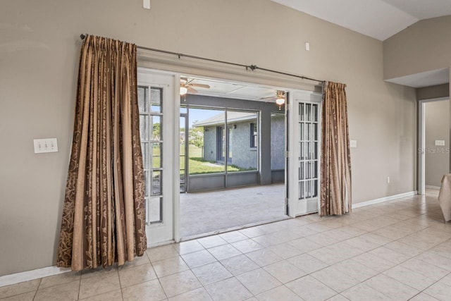 unfurnished room with ceiling fan, light tile patterned flooring, and lofted ceiling