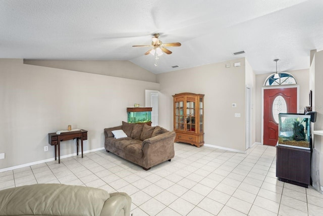 living room with ceiling fan, light tile patterned floors, and vaulted ceiling