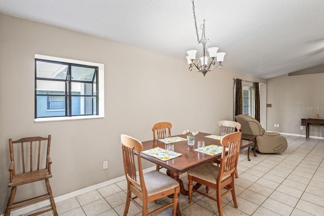 dining room featuring light tile patterned flooring, a textured ceiling, and a notable chandelier