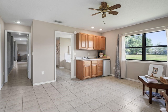 kitchen with ceiling fan, sink, light tile patterned floors, and white refrigerator