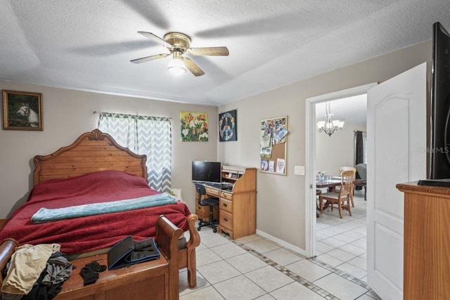 tiled bedroom with ceiling fan with notable chandelier and a textured ceiling