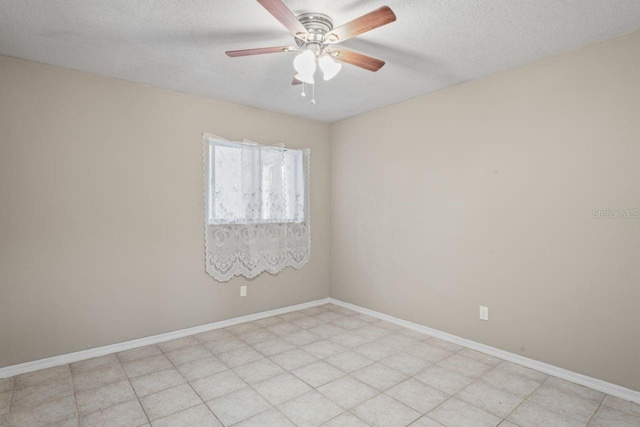 unfurnished room featuring ceiling fan and a textured ceiling