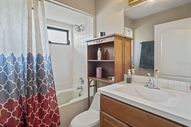 full bathroom with vanity, shower / bath combo, and toilet