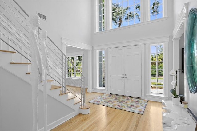 entrance foyer with plenty of natural light and light hardwood / wood-style flooring