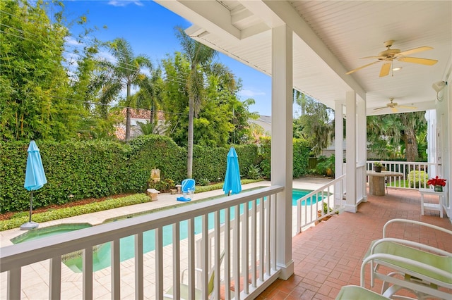 balcony featuring a patio area, ceiling fan, and a fenced in pool