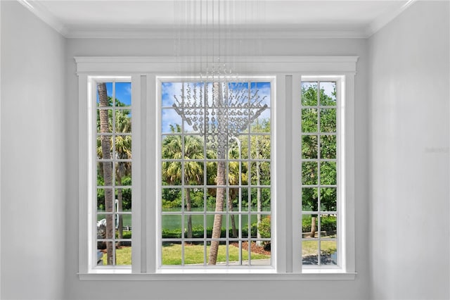 doorway with a wealth of natural light, a notable chandelier, and crown molding