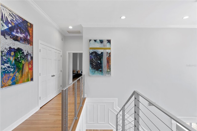 hall featuring crown molding and light wood-type flooring