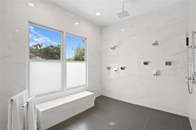 bathroom with a tile shower and tile flooring