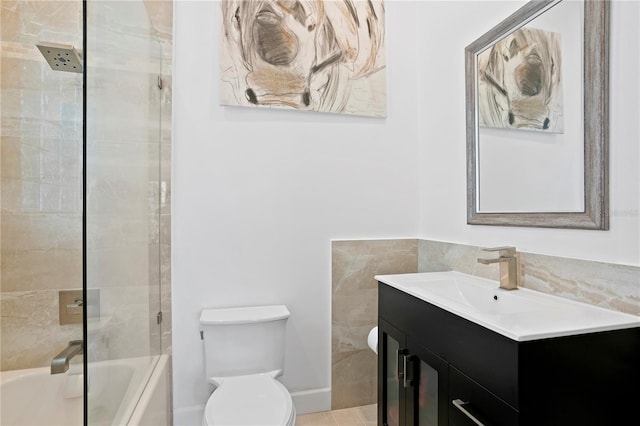 full bathroom with toilet, shower / bath combination with glass door, and vanity