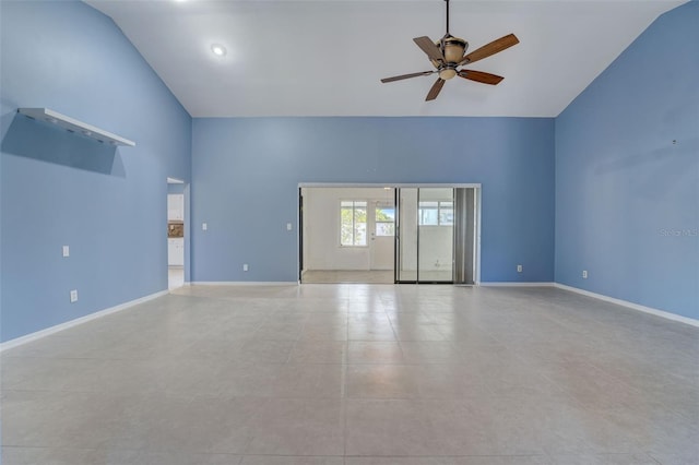 unfurnished living room featuring ceiling fan, light tile patterned floors, and vaulted ceiling